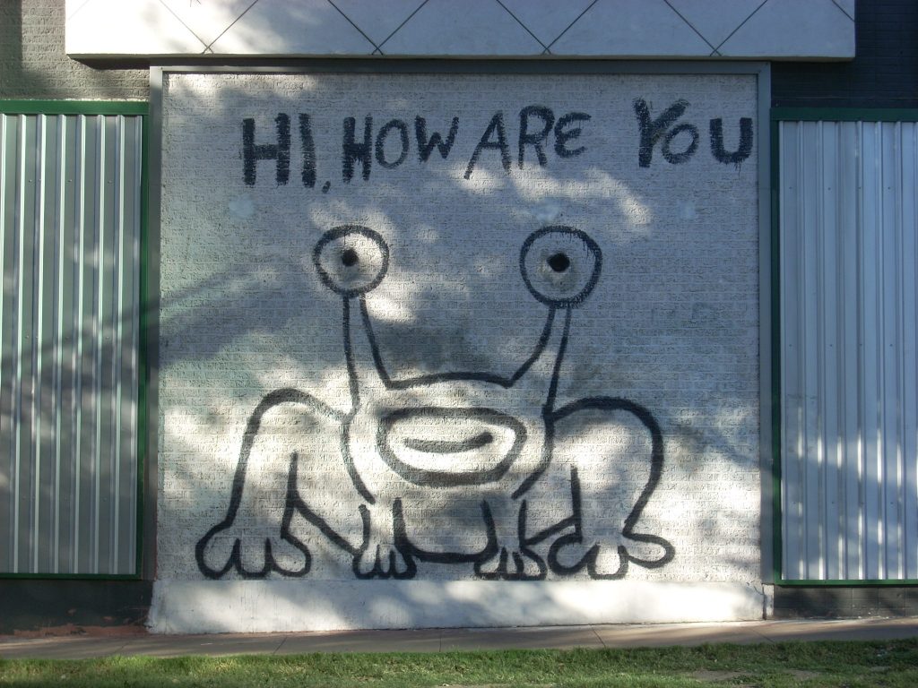 A photograph of a large mural by artist Daniel Johnston on a wall in Austin, TX.