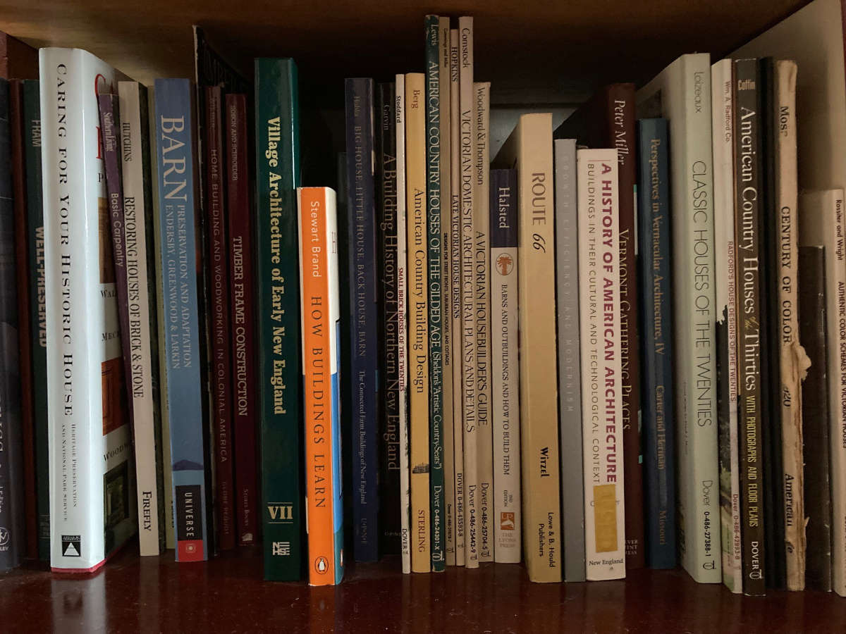 A detail photo of books on a shelf with titles related to historic preservation. 
