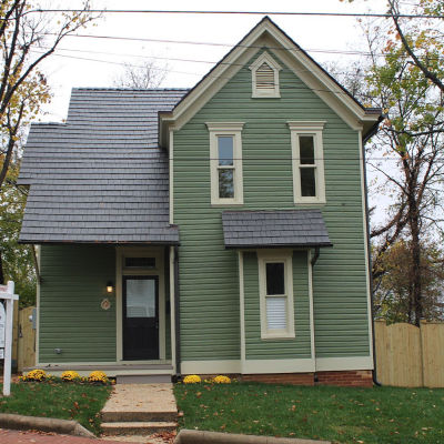 A green-painted house that was recently rehabilitated by the L'Enfant Trust in Washington, DC.