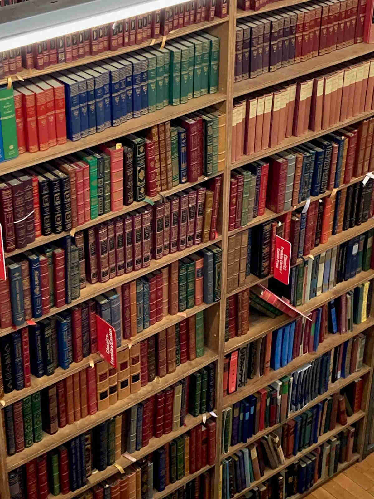 A photograph of a section of a large bookshelf with many brightly colored spines.