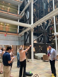 Attendees of the 2023 Spring Retreat viewing the atrium space at the former Peerless Department store in Providence, RI., now used for apartments and shops.